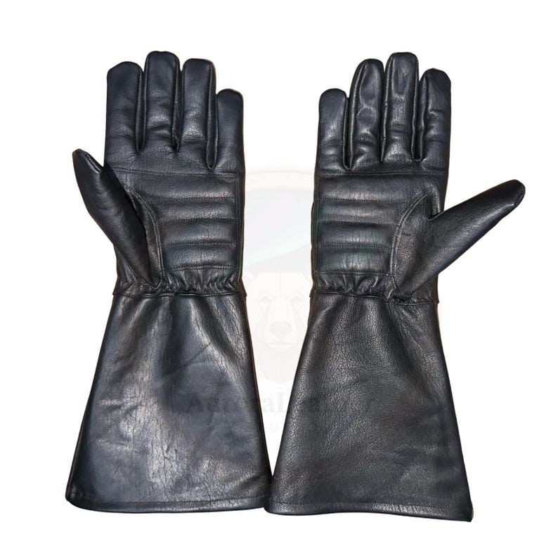 May include: A pair of black leather gloves with a gauntlet style cuff. The gloves have a quilted design on the back of the hand and fingers. The gloves are designed for protection and are likely used for work or sport.