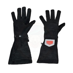 May include: A pair of black leather gloves with extended cuffs. The gloves have a button and strap closure at the wrist and a red and silver patch on the back of the hand. The gloves are designed for protection and durability.