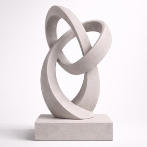May include: A light gray abstract sculpture featuring two intertwined loops, resting on a square base. The sculpture has a smooth, textured surface and a modern design. This decorative piece is suitable for home or office decor.