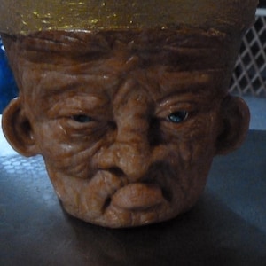 this is a 6-inch hand sculpted polymer over terra cotta pouty planter