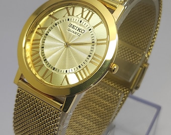 Reloj de pulsera vintage Seiko Slim de cuarzo con esfera dorada y acero inoxidable para hombre