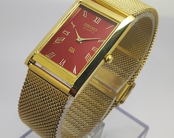 Reloj de pulsera vintage Seiko Slim de cuarzo con esfera roja y acero inoxidable para hombre, fabricado en Japón.
