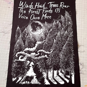 May include: A rectangular black fabric patch featuring a white screen-printed illustration of a forest at night under a large moon. The text reads: Winds Howl. Trees Roar The Forest Finds ITS Voice Once More. A small animal is visible in the foreground.