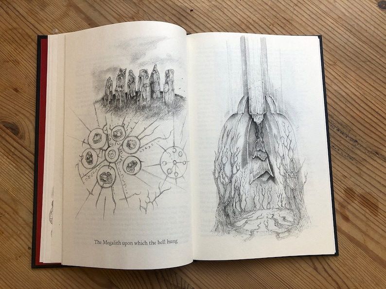 May include: Open book with two detailed pencil illustrations. One depicts a stone structure with a circular diagram. The other shows a tall, draped figure with a textured base. The text at the bottom reads: "The Megalith upon which the bell hung."