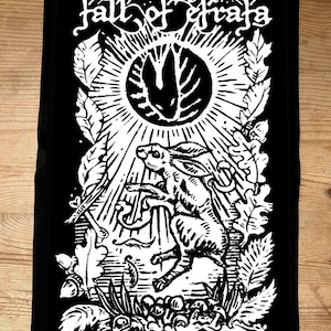 May include: Black and white graphic patch with a rabbit leaping in front of a sunburst design. The text "fall of efrafa" is arched above the sun. The design includes leaves and other natural elements.