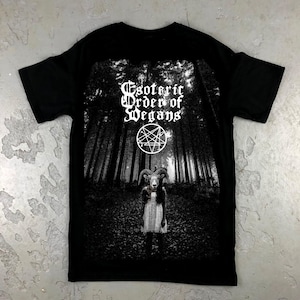 May include: Black t-shirt with a graphic print of a forest scene, a pentagram, and a figure with a goat head. The text "Esoteric Order of Vegans" is printed on the shirt.