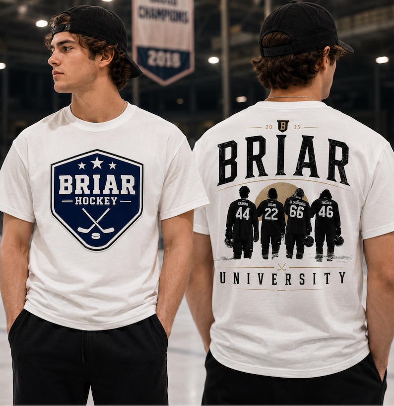 May include: White t-shirt with a navy blue and white hockey-themed graphic on the front. The graphic includes the text "BRIAR HOCKEY" and crossed hockey sticks. The back of the shirt features the word "BRIAR" and silhouettes of hockey players.