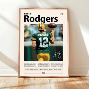 May include: A framed poster with a photograph of a football player in a green and yellow uniform, with the name "Rodgers" in large black letters. The player is holding a football. The poster includes the number 12 and an autograph.