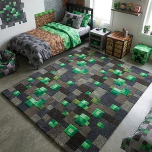 May include: A rectangular area rug featuring a pixelated block pattern in shades of dark gray, light gray, and vibrant green. The rug has a textured, tufted surface with raised green squares and a small rectangular brand tag attached to one corner.
