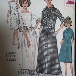 May include: A vintage sewing pattern envelope illustration featuring four dress designs. Styles include a floral shift dress, a white gown with ruffled sleeves and hem, a black and white gingham button-front dress with a bow, and a solid teal coat dress.