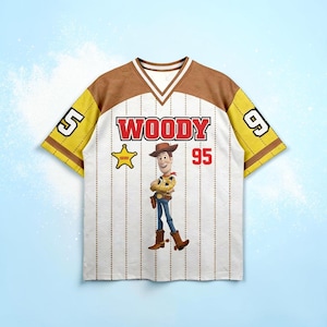 May include: White baseball-style jersey with brown and yellow accents. The jersey features the name "WOODY" in red, the number "95", and an image of the character Woody from Toy Story. The sleeves have the numbers "5" and "9".