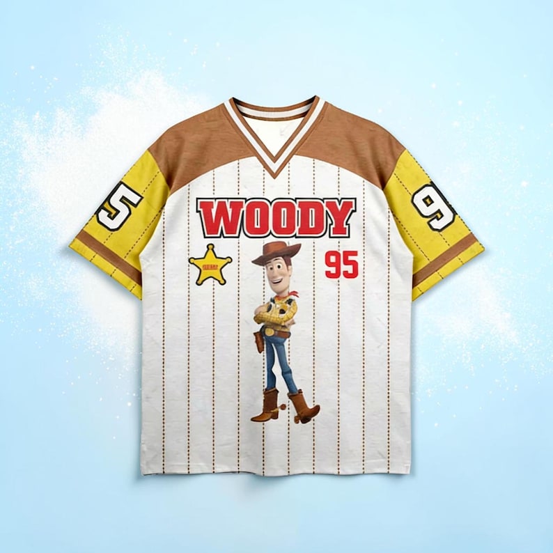 May include: White baseball-style jersey with brown and yellow accents. The jersey features the name "WOODY" in red, the number "95", and an image of the character Woody from Toy Story. The sleeves have the numbers "5" and "9".