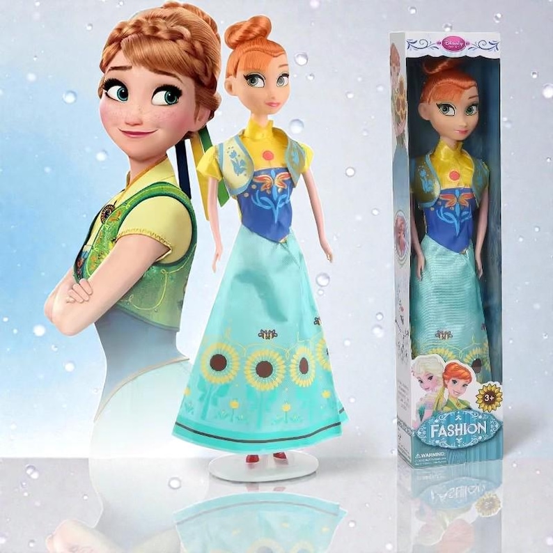 May include: A doll with red hair, dressed in a yellow top, blue vest, and a long blue skirt adorned with sunflower patterns. The doll stands on a white base. A boxed version of the doll is also shown.