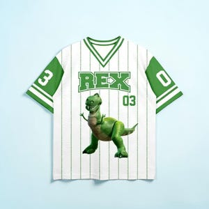 May include: White baseball-style jersey with green accents and vertical pinstripes. The front features the name "REX" in green block letters above a green cartoon dinosaur and the number "03". The sleeves have the numbers "3" and "0".