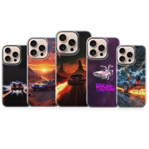 May include: Five phone cases with colourful graphics of the DeLorean time machine from "Back to the Future." The cases display scenes with fiery skies, desert landscapes, and the iconic car in action. The cases have a clear border.