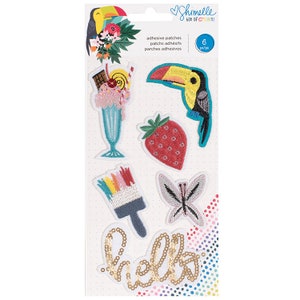 May include: A sheet of six adhesive patches with embroidered designs. The patches include a toucan, a milkshake, a strawberry, a paintbrush, a butterfly, and the word "hello" in gold sequins. The sheet is labeled "Shimelle Box of Crayons".