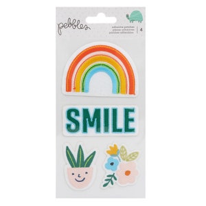 May include: A pack of four colorful iron-on patches featuring a rainbow, the word "SMILE", a potted plant with a smiley face, and a cluster of flowers. The patches are adhesive and can be used to decorate clothing, bags, and other items.