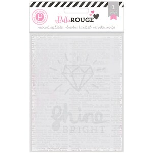 May include: A clear plastic embossing folder with a diamond and the words "Shine Bright" on a white background. The folder is packaged in a clear plastic sleeve with a pink and black label that says "Bella Rouge" and "embossing folder".