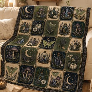 May include: A woven throw blanket featuring a grid of rectangular panels with botanical and celestial illustrations, including mushrooms, moths, pumpkins, glass bottles, and crescent moons in shades of deep green, navy blue, and cream.