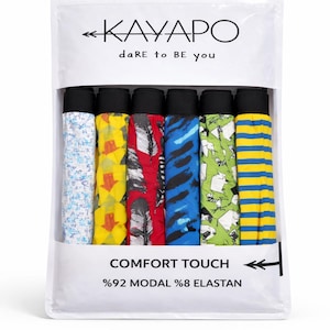Könnte beinhalten: Eine Packung bunter Unterwäsche mit verschiedenen Mustern, darunter Blumen, Pfeile, Federn und Streifen. Die Verpackung trägt den Text "KAYAPO dare to be you" und "COMFORT TOUCH". Das Material besteht aus 92 % Modal und 8 % Elasthan.