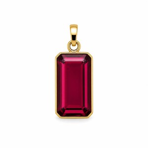 May include: A rectangular pendant featuring a deep red, emerald-cut gemstone set in a polished yellow gold frame. The pendant includes a matching yellow gold bail at the top, designed for attachment to a chain, showcasing a clean, symmetrical design.