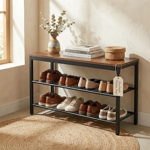 May include: A white ceramic mug with a black handle and the text "But First, Coffee" in a bold, black font. The mug is set against a blurred background, suggesting a cozy setting.