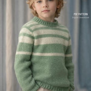 May include: A child wearing a green and white striped sweater. The sweater has a crew neck and long sleeves. The text "PDF PATTERN Digital Download" is in the upper right corner.