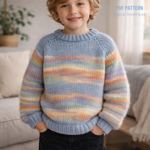 May include: A light blue knit sweater with horizontal stripes of pastel colors. The sweater has a crew neck and raglan sleeves. The text "PDF PATTERN Digital Download" is in the upper right corner. The sweater is worn by a child.
