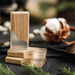 May include: Three rectangular USB flash drives featuring a combination of light-toned wood and frosted, semi-transparent resin. One drive stands vertically while two are stacked horizontally, showcasing a smooth, natural wood grain finish.