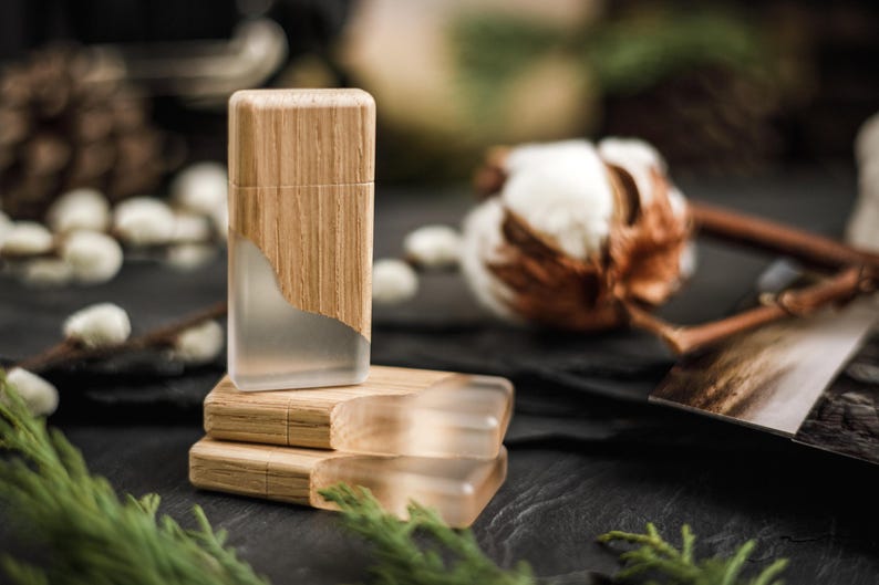 May include: Three rectangular USB flash drives featuring a combination of light-toned wood and frosted, semi-transparent resin. One drive stands vertically while two are stacked horizontally, showcasing a smooth, natural wood grain finish.
