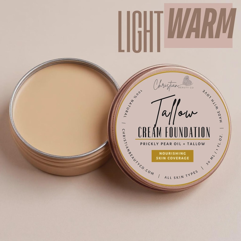 May include: Open tin of light warm-toned Tallow Cream Foundation. The product is made with prickly pear oil and tallow, and is designed for nourishing skin coverage. The label reads "Christian Beauty Co."