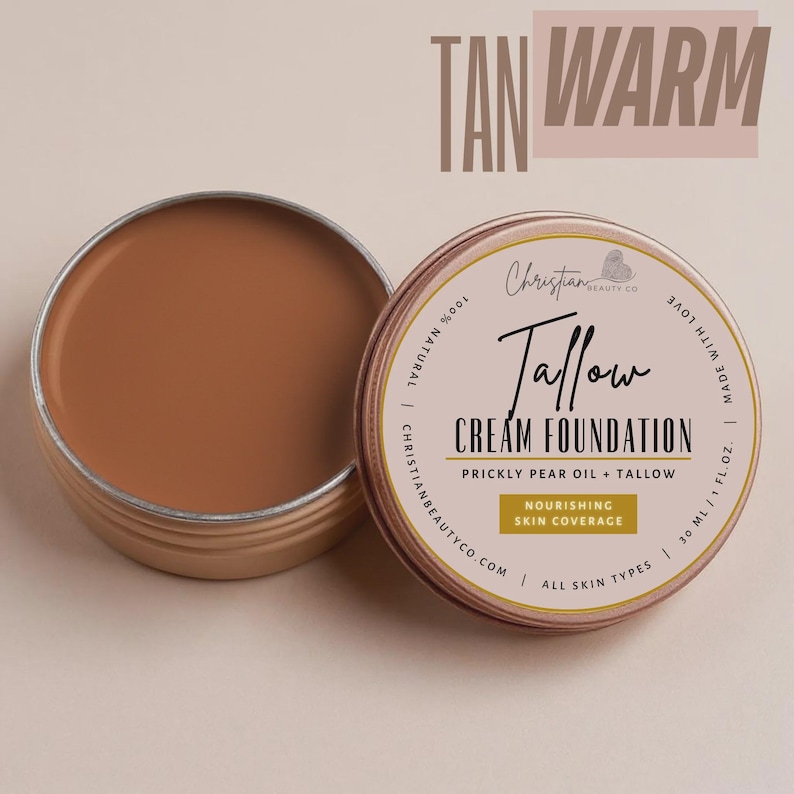 May include: Open tin of tan-colored Tallow Cream Foundation with the text "Tan Warm" above. The product is made with prickly pear oil and tallow, and is designed for nourishing skin coverage. The label reads "Christian Beauty Co."