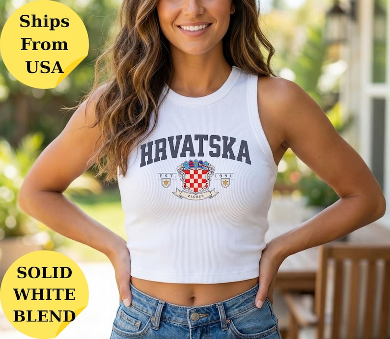 May include: A white ribbed tank top featuring the text HRVATSKA in dark blue letters above a colorful coat of arms emblem with a red and white checkered shield, the text EST. 1991, and the word ZAGREB printed on a banner below the crest.