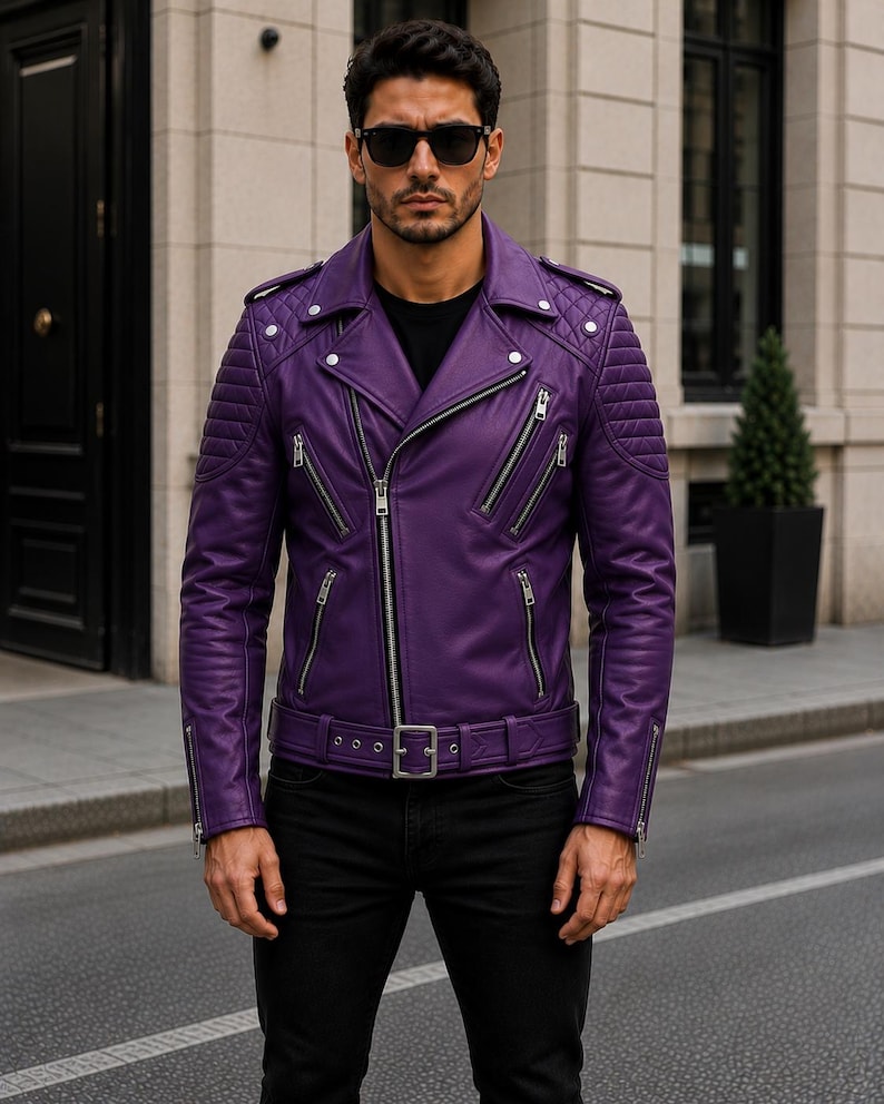 Man wearing purple leather biker jacket with quilted sleeves, asymmetrical front zipper and belted waist in an urban evening setting.