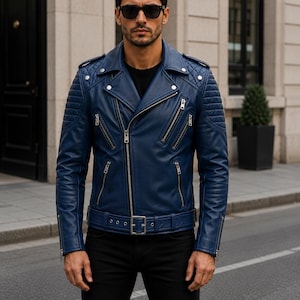 Man wearing blue leather biker jacket with quilted sleeves, asymmetrical front zipper and belted waist in an urban evening setting.