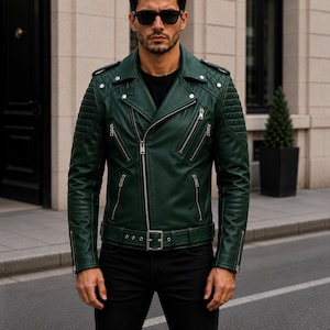 Man wearing green leather biker jacket with quilted sleeves, asymmetrical front zipper and belted waist in an urban evening setting.