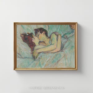 May include: A framed artwork depicts a couple embracing in bed, rendered in soft pastel colors. The figures are in a tender embrace, with the woman's red hair contrasting against the blue-green bedding. The artwork is in a gold frame.