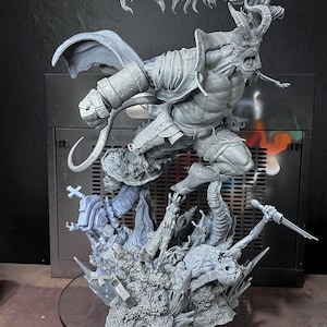 May include: A detailed gray figurine of a horned demon wielding a large sword, leaping over a detailed base with other figures. The figurine has intricate armor and a flowing cape. The base includes a cross and other detailed elements.