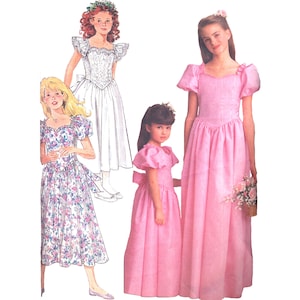 May include: Three girls wearing different styles of white and pink dresses. The girl in the middle is wearing a pink dress with a sweetheart neckline and puffed sleeves. The girl on the left is wearing a white dress with a floral pattern. The girl on the right is wearing a white dress with a lace bodice and ruffled sleeves.