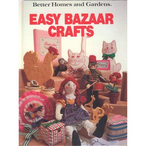 May include: The cover of a vintage craft book titled "Easy Bazaar Crafts" by Better Homes and Gardens. The cover features various handmade crafts, including a doll, wooden cutouts, and fabric decorations.