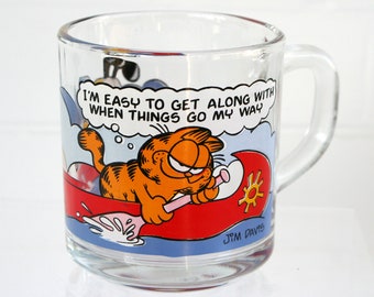 Vintage 1990s glass Garfield mug from McDonalds, Anchor Hocking clear coffee cup, colorful Sunday comic strip, cartoon cat humor, Odie dog