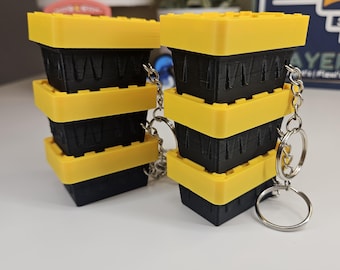 Llavero antiestrés con forma de caja de almacenamiento impresa en 3D / Tapa de panal con clic, color amarillo y negro.