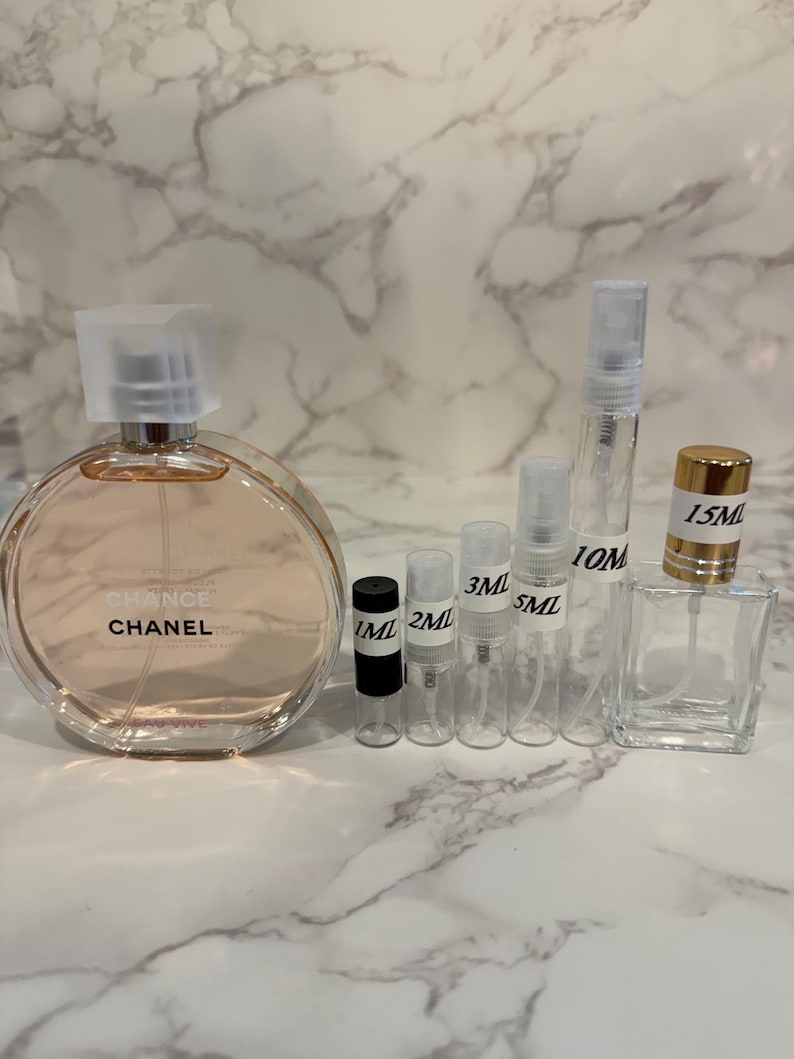 Puede incluir: Una botella de perfume y varios viales peque&ntilde;os y transparentes de diferentes tama&ntilde;os. La botella grande y redonda lleva la etiqueta "Chance" de Chanel. Los viales est&aacute;n etiquetados con medidas de 1 ml a 15 ml, lo que indica tama&ntilde;os de muestra.