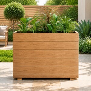 May include: A rectangular planter box constructed from horizontal light brown wooden planks. The planter features a clean, linear design with visible wood grain texture and is filled with various green leafy plants of differing heights and shapes.