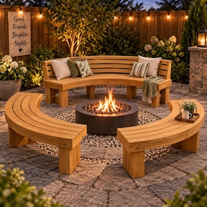 May include: A curved wooden bench set arranged in a semi-circle around a circular black fire pit on a stone patio. The benches feature horizontal slats and are accented with throw pillows and a green throw blanket. A sign reads Good Friends Brighter Nights.