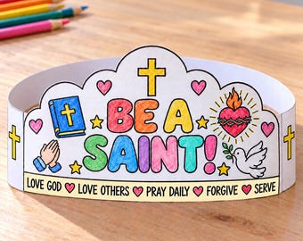 May include: A paper crown featuring the text BE A SAINT! in colourful letters, surrounded by illustrations of a blue Bible, a flaming heart, a white dove, and praying hands. The base includes the text LOVE GOD, LOVE OTHERS, PRAY DAILY, FORGIVE, SERVE.