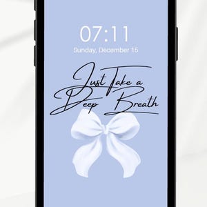 May include: A white ceramic mug with a black handle and the text "But First, Coffee" in a bold, black font. The mug is set against a neutral background, highlighting its simple design.