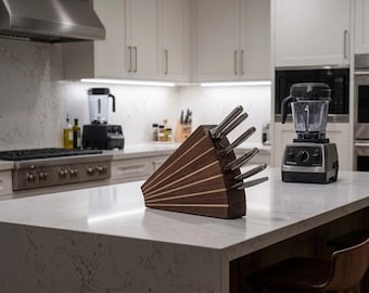 May include: A fan-shaped wooden knife block made of dark walnut with light wood accents, holding five stainless steel knives with metallic handles. The block features a distinct wedge design with visible grain patterns and a smooth finish.