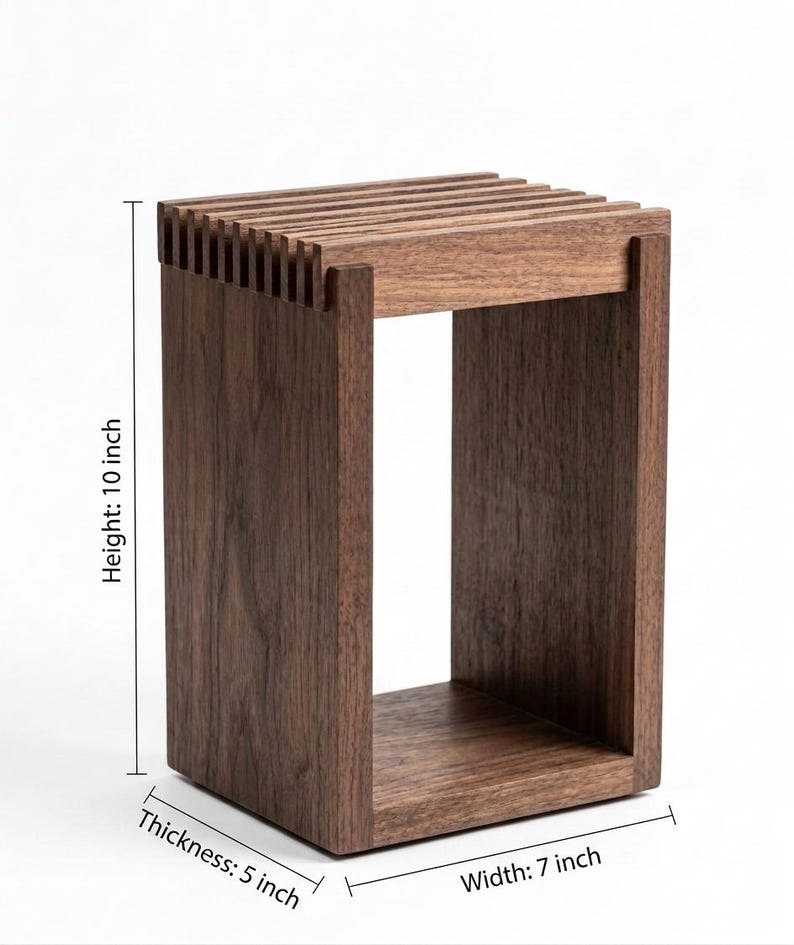 May include: A rectangular dark brown wooden stool with a slatted top surface. The structure features vertical side panels and a solid base. Dimensions are clearly labeled as 10 inches in height, 7 inches in width, and 5 inches in thickness.