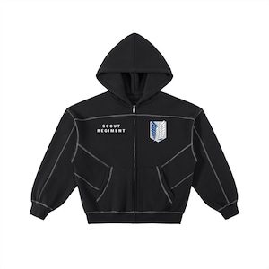 May include: Black hooded zip-up sweatshirt with white stitching. It has the text "SCOUT REGIMENT" and a winged emblem in white, blue, and grey. The hoodie has two front pockets and a full-length zip.